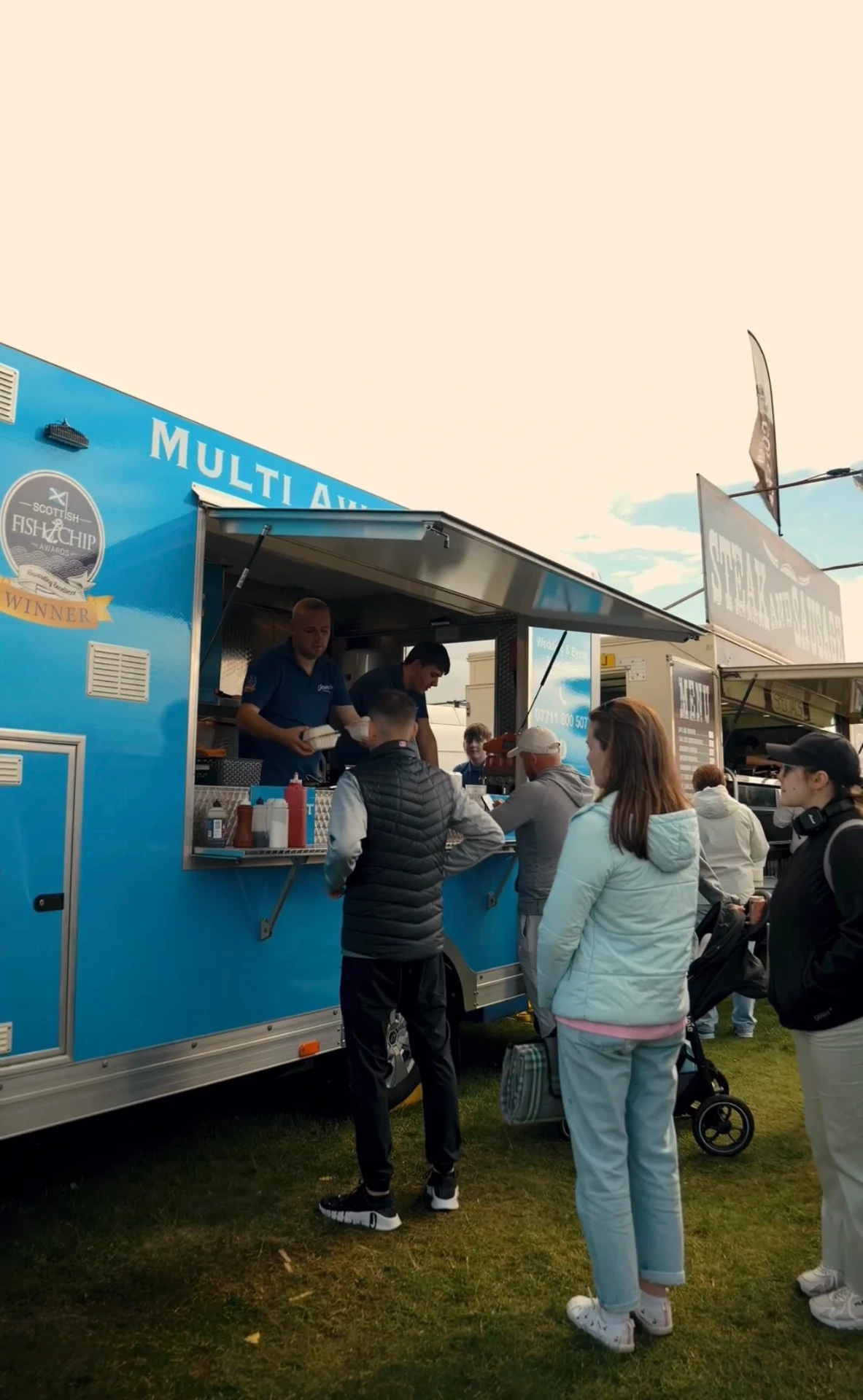 Customers ordering from Joanna's Chippy Van at a festival