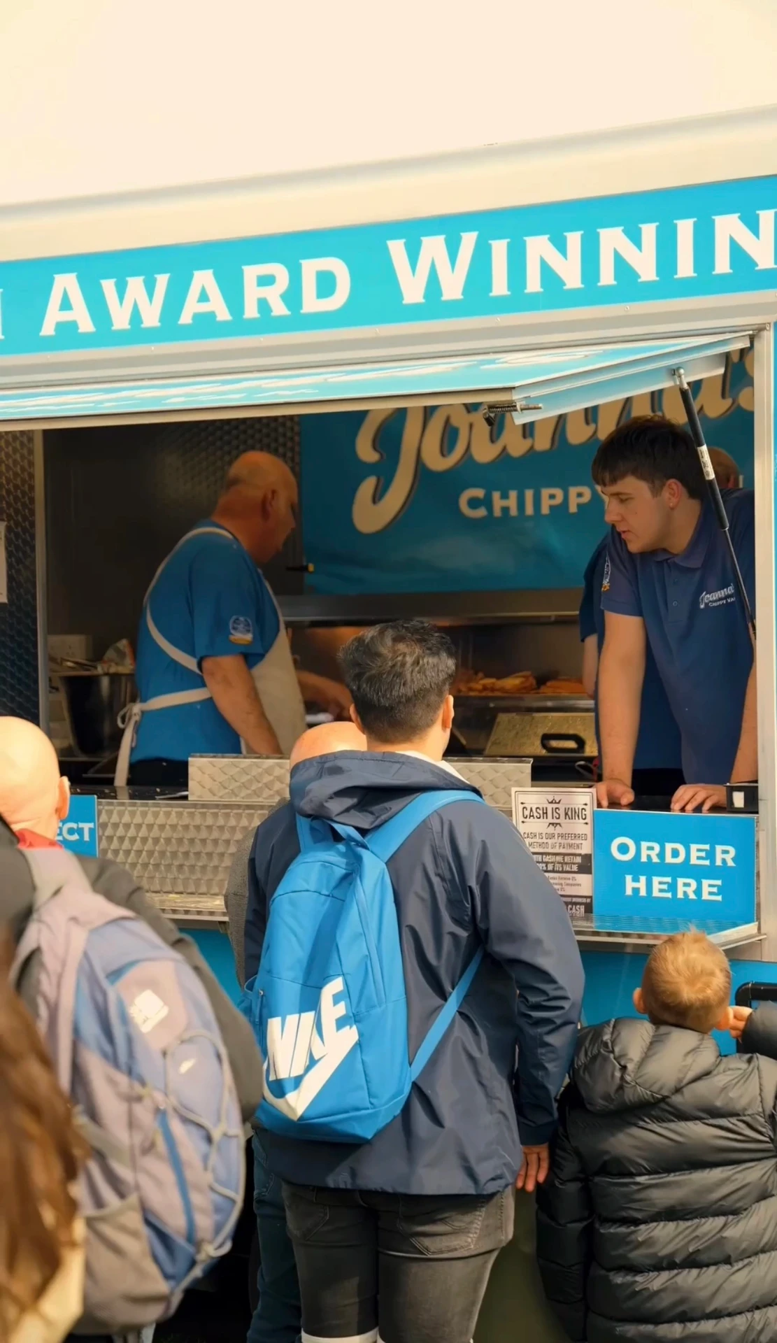 Joanna's Chippy Van team serving guests at an outdoor event